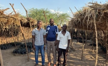 Community members Jalphy, John and Yowasi showcase their nursery 