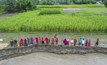 For the community of Vati Kapasia, Sundarganj, life is a relentless struggle against the constant threat of losing homes and croplands to riverbank erosion, followed by the challenge of relocating to areas further from the river's edge. This char, a river basin area along the Teesta River in Sundarganj, stretches across Gaibandha to meet the mighty Brahmaputra. Photo: Saikat Mojumder/Concern Worldwide