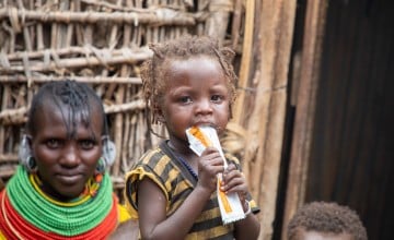 In Kenya, 19-month-old Midina eats a packet of RUTF. (Photo: Gavin Douglas/Concern Worldwide)