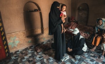 A community health volunteer in Tuban district visits Hana*'s home for a follow up check up on her malnourished daughter Oma*. Photo: Ammar Khalaf/Concern Worldwide