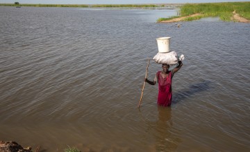 Nyakeok Top Leny (56) returns from harvesting water lilies in the flooded waters of Bentiu, South Sudan. (Photo: Eugene Ikua/Concern Worldwide)