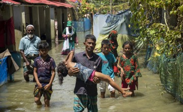 Residents of Noakhali district, Bangladesh, make their way through flooded streets, August 2024. (Photo: Akram Hossain/Concern Worldwide)