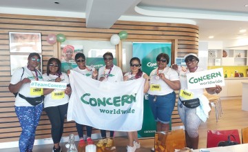 Group of women holding Concern banner