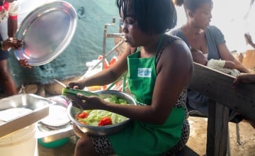 Woman cooking Haitian meal in Port au Prince