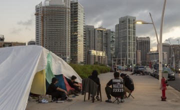 Ahmad* (45), Mazen* (18), Mariana* (37), Hashem* (15) and Leila* (13), sit in front of their tent that they had set up on the sidewalk near the Zeytouna Bay, in Beirut. (Photo: Dalia Khamissy/Concern Worldwide)