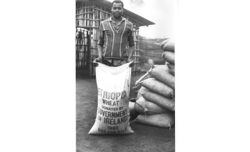 A man holding a bag of wheat shipped from Ireland to Ethiopia during the 1984-85 famine. (Photo: Concern Worldwide)