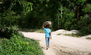 A young boy walks home from the market along a road in rural Haiti. (Photo: Kieran McConville/Concern Worldwide)