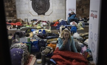 A woman sits on the floor in Heroiv Pratsi metro station in North Eastern Kharkiv