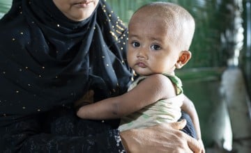 Baby Anwar in his mother's arms