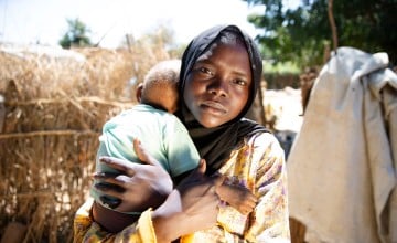 Samiya* with her one-year-old son, Faheem*, who was treated for malnutrition at a clinic near Ardamat, West Darfur, Sudan. The clinic, which had been ransacked and looted when the conflict reached the area was repaired and reopened by Concern, with funding from the European Union. Photo: Kieran McConville/Concern Worldwide