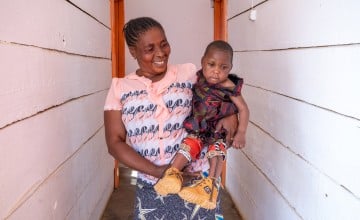 Francine Kavira Vake is caring for her granddaughter Christivie, who has difficulties sitting independently, walking and talking