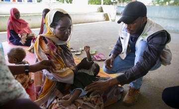 Health and Nutrition Coordinator, Hamdoon Abdala, with Zarina* and baby Yaqub* at Ardamata Health Centre in West Darfur. Photo: Kieran McConville/Concern Worldwide