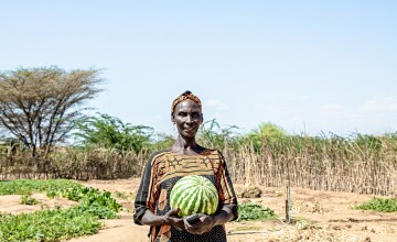 Ruth Epat Koli shows off watermelon she has grown