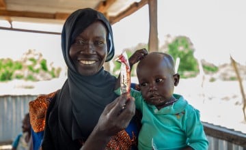 Ayaan holds a sachet of ready-to-eat therapeutic food (RUTF) at the Lueth Ngor PHCU (Public Health Care Unit) in Aweil. Photo: Eugene Ikua/Concern Worldwide