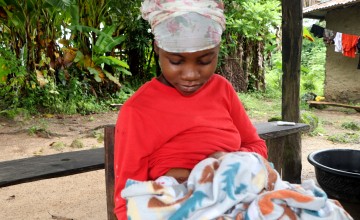 Evelyn Somah, a resident of Kardorpuee Town, feeds her two-week-old baby. The Liberia WASH Consortium project is key on strengthening health systems for new and expecting mothers and their children. Photo: Concern Worldwide
