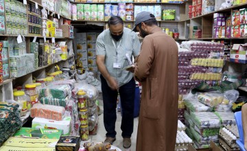 A man in Al-Manghiya, Syria, shops at a local grocery store using a food voucher provided by Concern. Photo: Hani Al-Ali/Concern Worldwide
