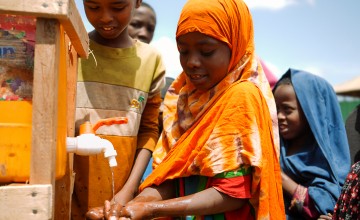 Mothers and children collect water and wash their hands at water wells constructed by Concern’s Emergency Programme in Baidoa, Somalia. Photo: Concern Worldwide