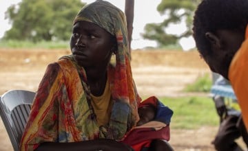 Yaldo* (19) and her baby Akuei* (2 months) at the Concern medical check-point at Kiir Adem border