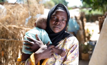 Samiya* with her one-year-old Faheem* in their village in Sudan, which they returned to in 2024, having been forced to flee in 2023.