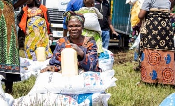 A beneficary waits for the vehicle to assist people with reduced mobility to return them to their homes. Photo: Samuel Isenge/Concern Worldwide