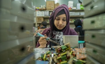 Rabeya Hawlader assembles circuits for solar controller boxes