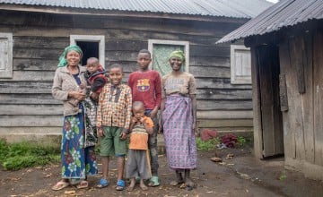Mutesi Mururugwerwa pictured with family members in front of the latrine and shower facilities that were built for her Photo: Samuel Isenge/Concern Worldwide