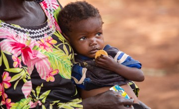 Sylvie is fed fortified porridge in a Concern clinic