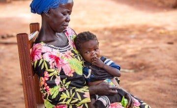 Dominique* holds her orphaned grandchild Sylvie*