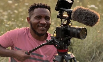 Mussa Uwitonze photographing in the field