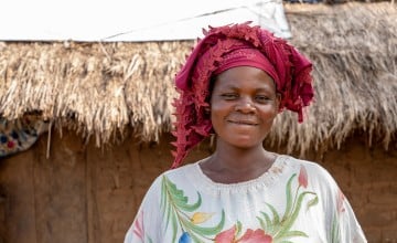 Maria Kasongo Mwabana outside her home in Kabutonga. She has been able to recover what was lost due to local conflict thanks in part to her local VSLA. Photo: Eugene Ikua / Concern Worldwide