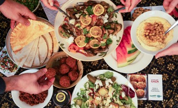  Dinner part scene shown from above. People share Palestinian food. 