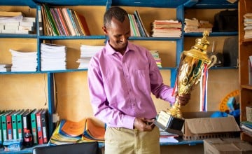 Boru Ali holds up a trophy won by his students from Bubisa Junior Secondary School at the 2023 Science Fair in Marsabit County. Photo: Eugene Ikua/Concern Worldwide