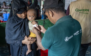 Ayesha* (25) a Rohingya mother visits the Concern nutrition center in Camp 13, Cox's Bazar, with her son Anwar* (9 months). Anwar has malnutrition and is being monitored. His mid-upper arm circumference (MUAC) is measured as part of this. Malnutrition is often diagnosed in children by measuring the MUAC as their bodies will use muscle and fat for fuel if a child doesn't have enough food. (Photo: Saikat Mojumder/Concern Worldwide)