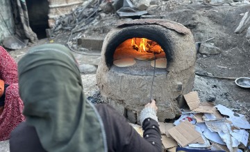 Manila* and her family were displaced to Rafah then to Al-Nuseirat in Gaza. She makes some bread with the resources they have, but they have no tent or access to food and water. (Photo: Khalil Adwan)