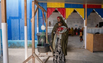 Hoodo* with 8-month-old Mulki* at a Concern-supported clinic near Mogadishu, where they traveled after attacks on their home village killed Hoodo's husband. “I knew my baby was sick, but I did not know where to take her because I feared being given medication I could not afford. Fortunately, the health workers from Concern visited the camp, saw my child, tested her, and gave her the RUTF and some medication to help with her symptoms.” Photo: Eugene Ikua/Concern Worldwide