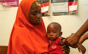 Amburo* (28) holds her youngest child Abshir*. Amburo is a mother of four children from Baidoa, now living in a displacement camp in Daynile District, Mogadishu. Photo: Adnan Mohamed/Concern Worldwide