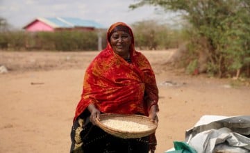 Ralia at her home with her harvested maize which she is currently putting in storage, Tana River, Kenya. Photo: Eugene Ikua/Concern Worldwide.