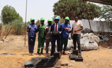 Karö CEO Bindah Dingaotabet Ghislain (centre), with several team members. The organisation collected over 12,800 empty RUTF packages from Concern Chad, recycling them into 600 bricks and paving stones. Photo: Pierre Maget/Concern Worldwide