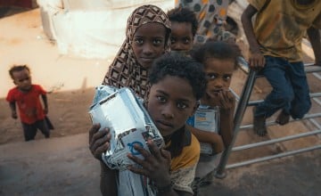 Local families receive nutritional supplementary food from the Concern supported health clinic in one of the displacement camps in Tuban district where Concern provides health and nutrition services. Photo: Concern Worldwide