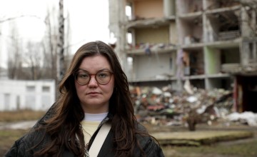 Jenny Gillen in front of destroyed building in Kharkiv