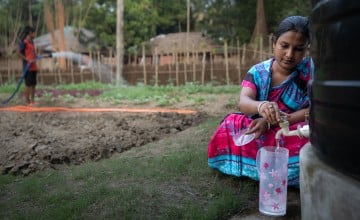 Pinky Ray pours herself safe drinking water to prepare meals for her family. Rainwater harvested throughout the last rainy season could serve her family for almost the rest of the year in Chordanga, Bangladesh. Photo: Mumit M/Concern Worldwide