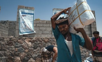 Concern team distribute shelter materials to people affected by a sandstorm that struck Al-Anad IDP Camp in Yemen's Tuban District, with support from Irish Aid. Photo: Ammar Khalaf/Concern Worldwide