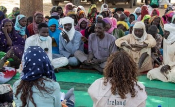 Representatives from the Irish Embassy to Sudan and Irish Aid sitting across from villagers in Sira, Chad