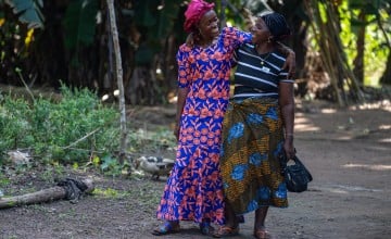 Rugiatu Kamara with her friend and fellow small-scale farmer Aminata Bangura. Aminata also participated in Yoti Yoti, which has helped her in raising her four children since the death of her husband. She adds that her farmers' group offers a safe space for mothers to spend time together, share their challenges, and support one another. (Photo: Eugene Ikua/Concern Worldwide)