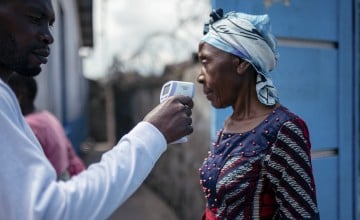 A staff member of the CBCA Virunga Hospital checks a visitor's temperature using a contactless infrared thermometer, before allowing her access to the hospital in Goma, DRC on May 17, 2026.