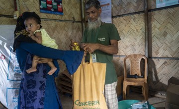 Dina* with her one-year-old child Barsha*, receives Super Cereal Plus, a fortified blend of wheat and soy that's rich in protein and nutrients. It's provided to pregnant and breastfeeding mothers at the Rohingya camp through Concern's Integrated Nutrition Facilities (INFs) in the camps.