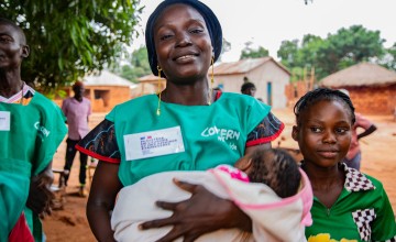 Mélanie*, a mother of 7 children, holds her youngest child. Photo: Mussa Uwitonze/Arete/Concern Worldwide.