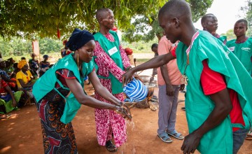 Mélanie*, a mother of 7 children, washes her hands before assisting with a cooking demonstration. Photo: Mussa Uwitonze/Arete/Concern Worldwide.