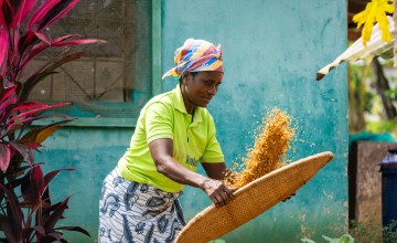 Cathrin Kubagh, at her home in Buchanan City. Through Concern's I-FaNSI program, Cathrin joined a local Community Savings and Loans Association and grows a range of crops including rice and vegetables, supporting her family and sending her children to school.