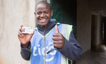 Jean Claude Minani shows off his prized motorcycle driver’s licence. He participated in Concern’s graduation programme in Rwanda and was able to start his own motorcycle taxi business. Photo: Robin Wyatt / Concern Worldwide, 2015.